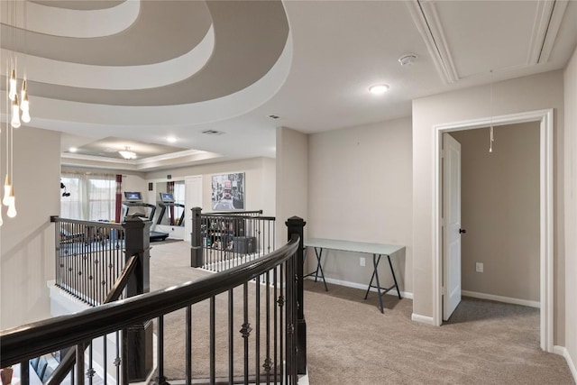 5400 Alonso Dr, Austin, TX 78738 - hall with attic access, a tray ceiling, an upstairs landing, light colored carpet, and baseboards