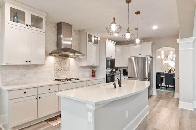 5400 Alonso Dr, Austin, TX 78738 - kitchen with wall chimney exhaust hood, stainless steel appliances, a sink, backsplash, and light countertops