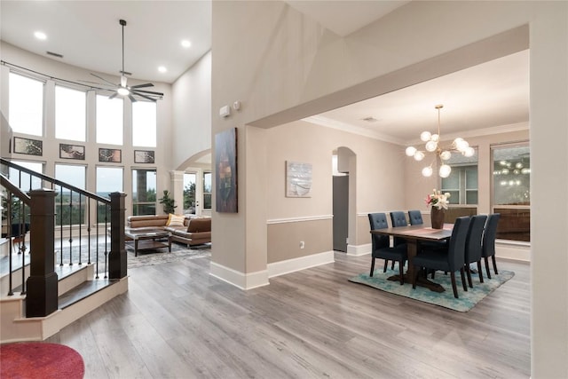 5400 Alonso Dr, Austin, TX 78738 - dining room featuring arched walkways, baseboards, stairs, wood finished floors, and a ceiling fan