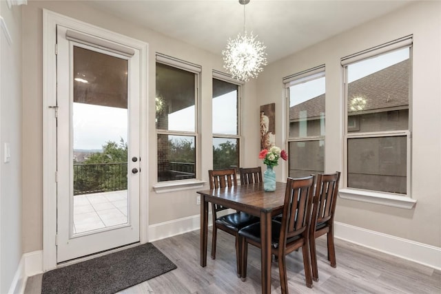 5400 Alonso Dr, Austin, TX 78738 - dining room featuring a chandelier, wood finished floors, and baseboards