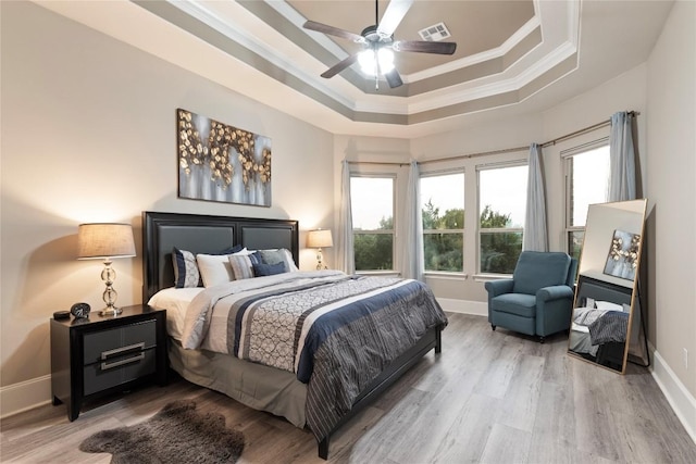 5400 Alonso Dr, Austin, TX 78738 - bedroom with ornamental molding, a tray ceiling, wood finished floors, and baseboards