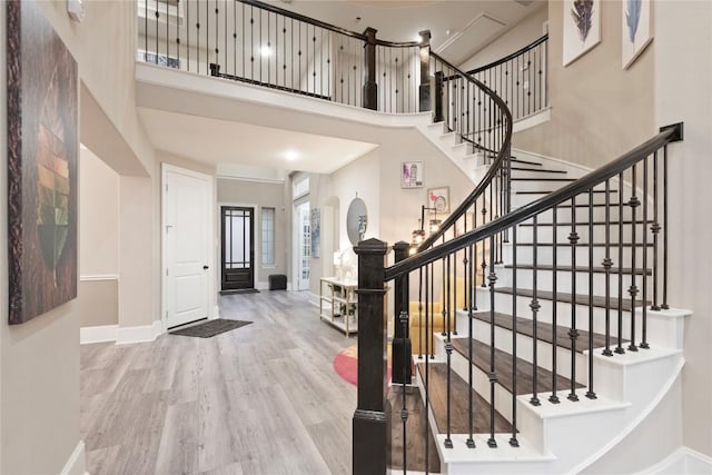 5400 Alonso Dr, Austin, TX 78738 - foyer with wood finished floors, baseboards, a towering ceiling, and stairway