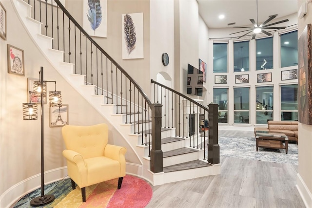 5400 Alonso Dr, Austin, TX 78738 - staircase with a high ceiling, wood finished floors, ceiling fan, and baseboards