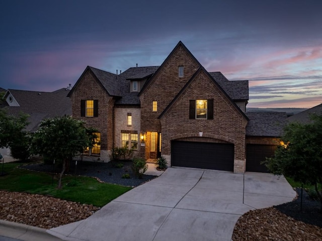 5400 Alonso Dr, Austin, TX 78738 - view of front of house featuring brick siding, driveway, and an attached garage