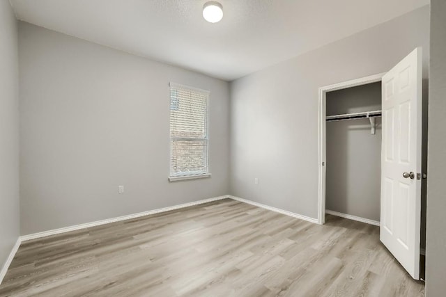 9008 Tall Sky Trce, Austin, TX 78724 - unfurnished bedroom featuring light wood finished floors, a closet, and baseboards