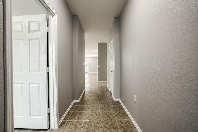9008 Tall Sky Trce, Austin, TX 78724 - hall with tile patterned flooring, baseboards, and a textured wall