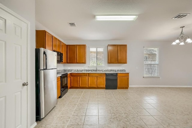 9008 Tall Sky Trce, Austin, TX 78724 - kitchen featuring black appliances, brown cabinetry, light countertops, a chandelier, and a sink