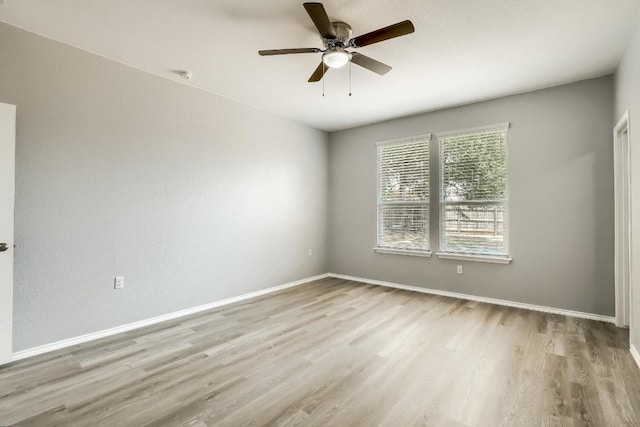 9008 Tall Sky Trce, Austin, TX 78724 - spare room with wood finished floors, ceiling fan, and baseboards