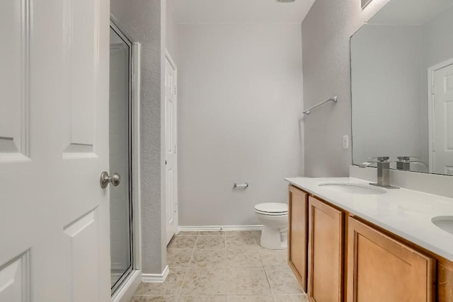 9008 Tall Sky Trce, Austin, TX 78724 - bathroom with double vanity, toilet, an enclosed shower, tile patterned floors, and baseboards
