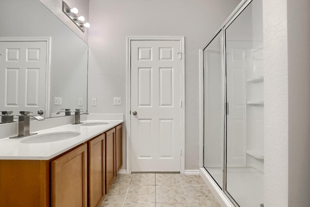 9008 Tall Sky Trce, Austin, TX 78724 - bathroom featuring double vanity, a stall shower, and tile patterned floors