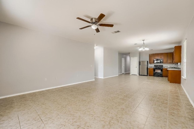 9008 Tall Sky Trce, Austin, TX 78724 - unfurnished living room featuring a sink, ceiling fan, a chandelier, and baseboards
