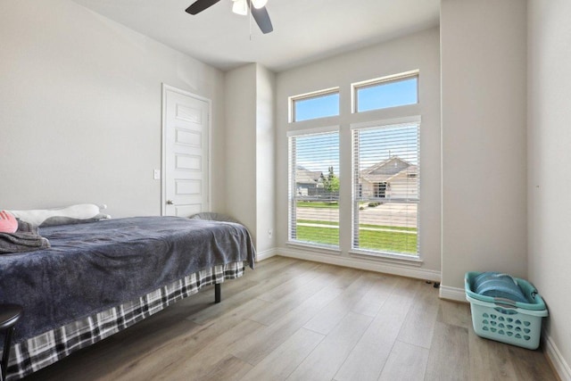 13212 Carol Lawler Ln, Manor, TX 78653 - bedroom featuring multiple windows, wood finished floors, and a ceiling fan