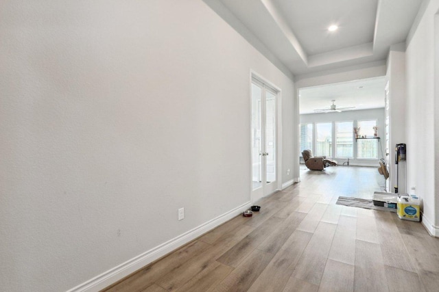 13212 Carol Lawler Ln, Manor, TX 78653 - hall with light wood-type flooring, french doors, recessed lighting, and a tray ceiling