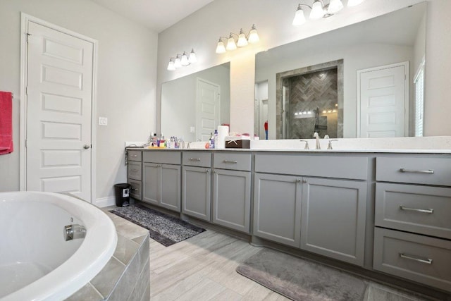 13212 Carol Lawler Ln, Manor, TX 78653 - full bathroom featuring double vanity, a garden tub, and a tile shower