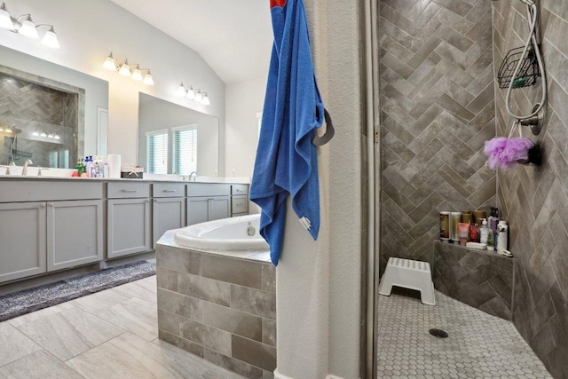 13212 Carol Lawler Ln, Manor, TX 78653 - full bath with double vanity, lofted ceiling, a tile shower, a bath, and marble finish flooring