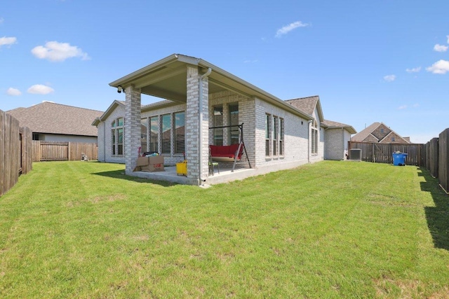 13212 Carol Lawler Ln, Manor, TX 78653 - back of property featuring a patio, a fenced backyard, and brick siding