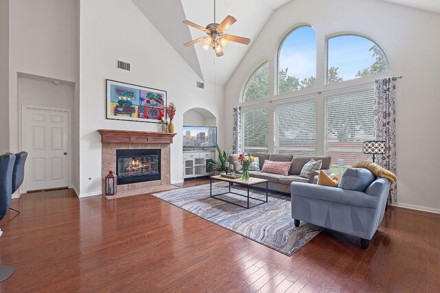 9905 Palmbrook Dr, Austin, TX 78717 - living room with a ceiling fan, a tile fireplace, high vaulted ceiling, wood finished floors, and baseboards