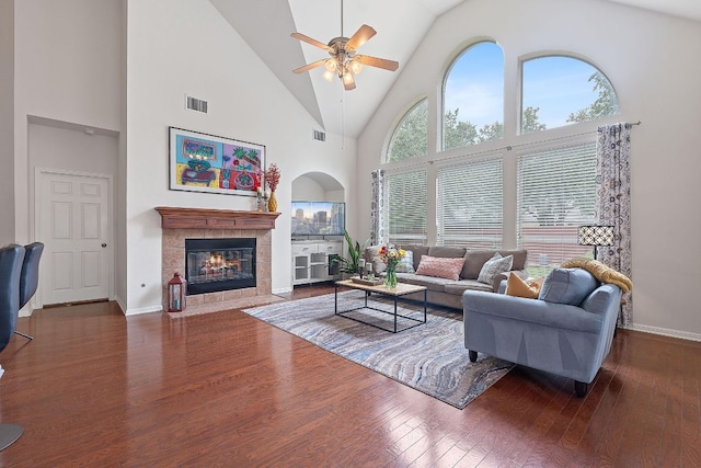 9905 Palmbrook Dr, Austin, TX 78717 - living area featuring a ceiling fan, a tiled fireplace, high vaulted ceiling, and wood finished floors