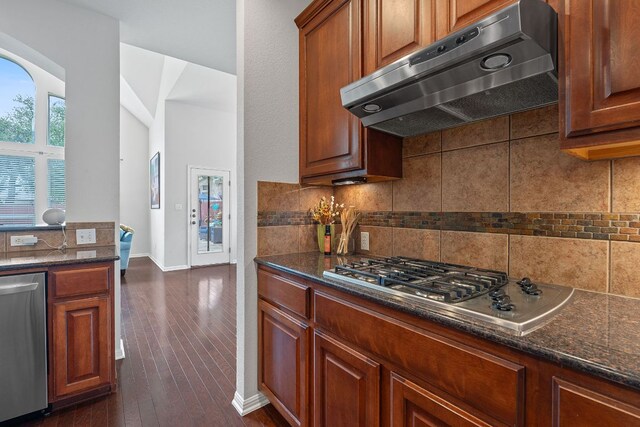 9905 Palmbrook Dr, Austin, TX 78717 - kitchen featuring under cabinet range hood, tasteful backsplash, appliances with stainless steel finishes, and dark stone countertops