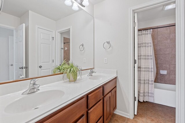 9905 Palmbrook Dr, Austin, TX 78717 - full bath featuring double vanity, shower / bathtub combination with curtain, tile patterned floors, and baseboards