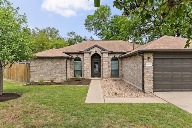 8005 Willet Trl, Austin, TX 78745 - french country home with an attached garage, brick siding, roof with shingles, and concrete driveway