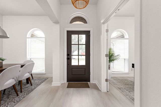 8005 Willet Trl, Austin, TX 78745 - entryway with light wood finished floors, healthy amount of natural light, baseboards, and a chandelier