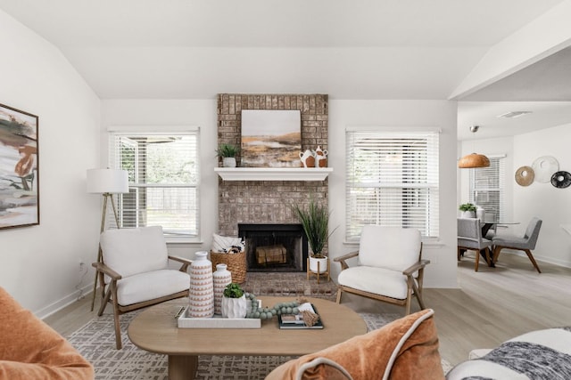 8005 Willet Trl, Austin, TX 78745 - living room featuring vaulted ceiling, a fireplace, wood finished floors, and baseboards