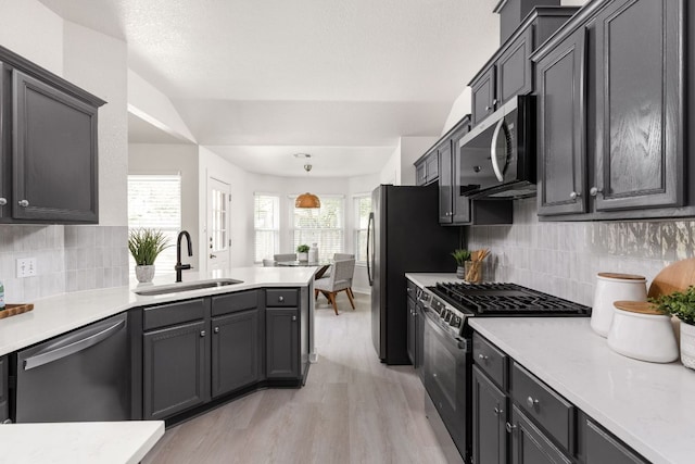 8005 Willet Trl, Austin, TX 78745 - kitchen with stainless steel appliances, a peninsula, light countertops, and tasteful backsplash