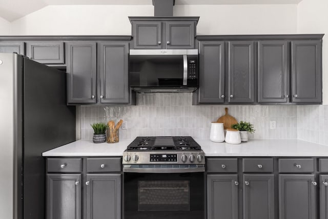 8005 Willet Trl, Austin, TX 78745 - kitchen with appliances with stainless steel finishes, gray cabinets, decorative backsplash, and lofted ceiling