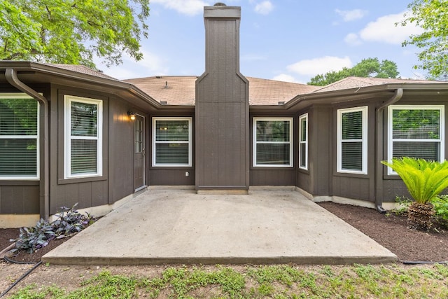 8005 Willet Trl, Austin, TX 78745 - rear view of property featuring a chimney, a patio area, and roof with shingles