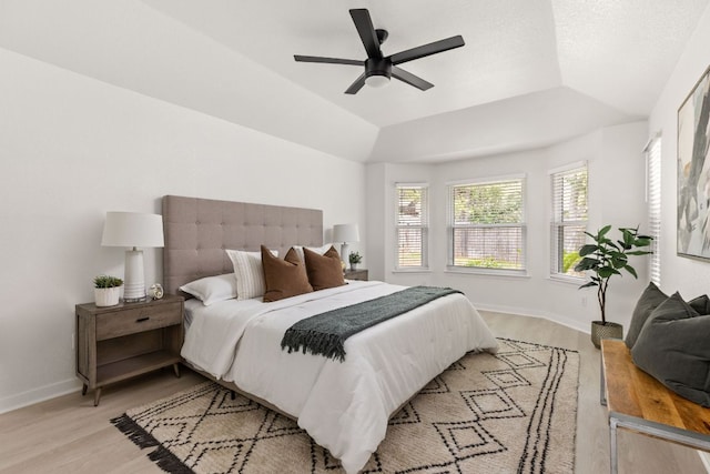 8005 Willet Trl, Austin, TX 78745 - bedroom featuring light wood-style flooring, a raised ceiling, and a ceiling fan