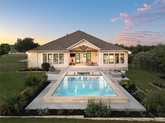 941 Linden Loop, Driftwood, TX 78619 - back of house at dusk featuring a patio, a fenced backyard, and an outdoor hot tub