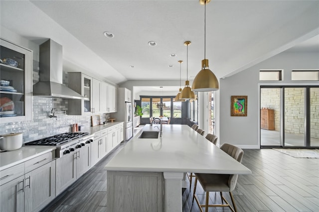 941 Linden Loop, Driftwood, TX 78619 - kitchen with exhaust hood, stainless steel appliances, dark wood-style floors, lofted ceiling, and backsplash