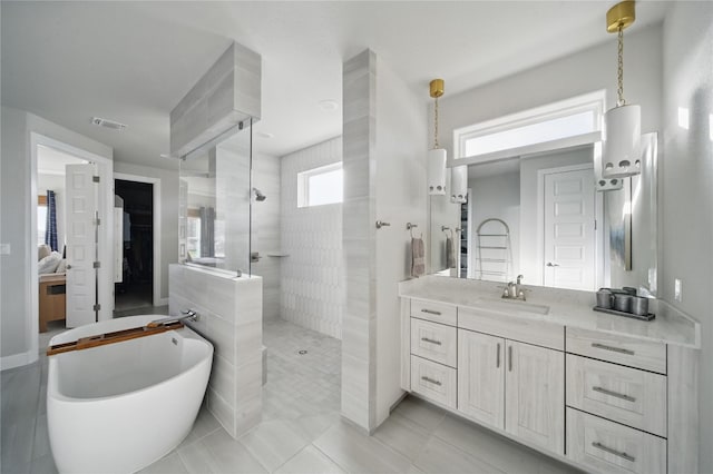 941 Linden Loop, Driftwood, TX 78619 - full bath with walk in shower, a soaking tub, vanity, and tile patterned flooring