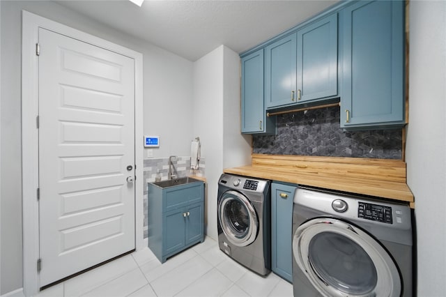 941 Linden Loop, Driftwood, TX 78619 - laundry area featuring cabinet space, washer and clothes dryer, light tile patterned floors, and a textured ceiling