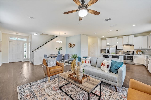 10612 Harwood Overlook Cv, Austin, TX 78747 - living room featuring stairway, a chandelier, recessed lighting, dark wood-style floors, and ceiling fan