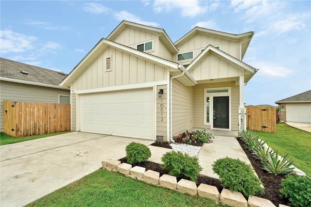 10612 Harwood Overlook Cv, Austin, TX 78747 - view of front facade featuring board and batten siding, driveway, an attached garage, and a gate