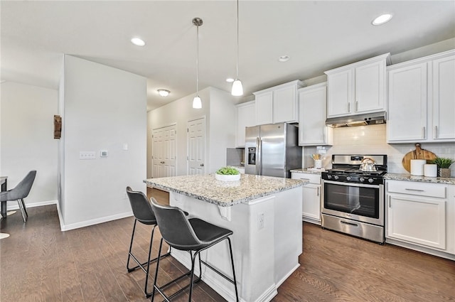 10612 Harwood Overlook Cv, Austin, TX 78747 - kitchen with stainless steel appliances, a center island, under cabinet range hood, dark wood finished floors, and recessed lighting