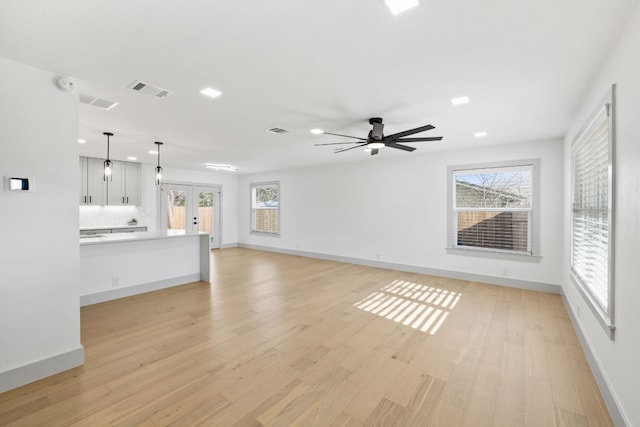 500 Arbor Ln, Austin, TX 78745 - unfurnished living room with light wood finished floors, french doors, baseboards, recessed lighting, and a ceiling fan