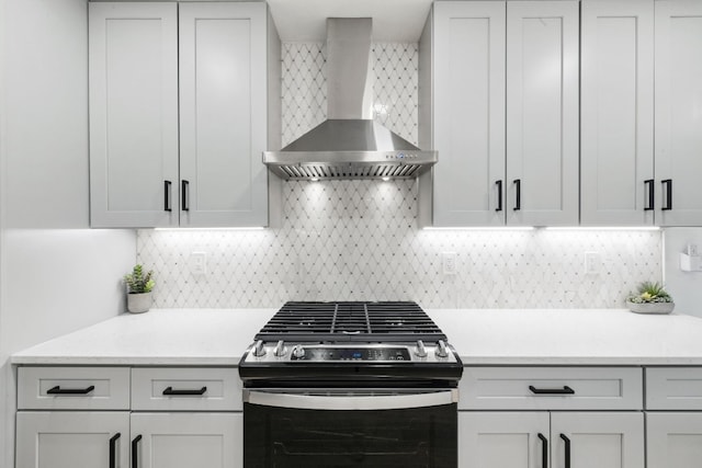 500 Arbor Ln, Austin, TX 78745 - kitchen featuring stainless steel gas range oven, wall chimney range hood, light countertops, and backsplash