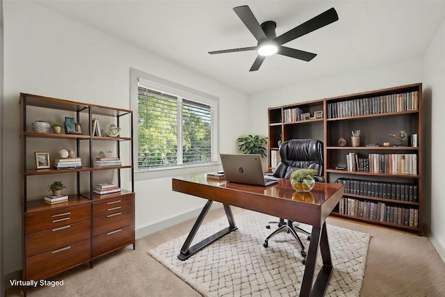 500 Arbor Ln, Austin, TX 78745 - home office featuring light colored carpet, a ceiling fan, and baseboards