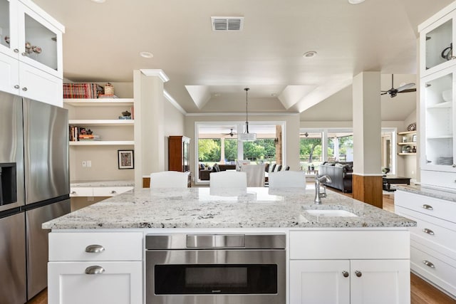 137 Lone Cypress Cv, Driftwood, TX 78619 - kitchen featuring appliances with stainless steel finishes, open floor plan, open shelves, dark wood-style flooring, and white cabinets