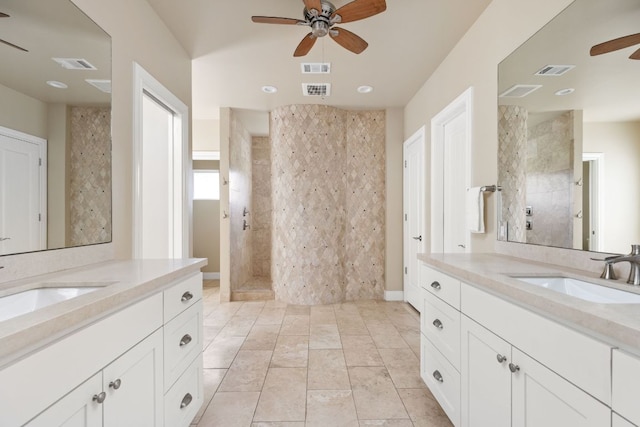 137 Lone Cypress Cv, Driftwood, TX 78619 - bathroom with ceiling fan, tiled shower, two vanities, and recessed lighting