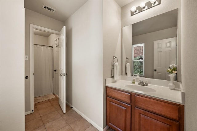 11113 Harvest Time Dr, Austin, TX 78754 - bathroom with vanity, tile patterned floors, and baseboards
