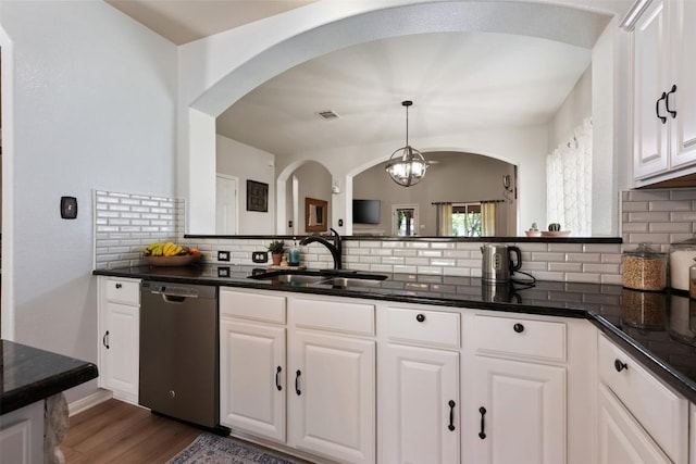 11113 Harvest Time Dr, Austin, TX 78754 - kitchen featuring dishwasher, a sink, tasteful backsplash, and arched walkways