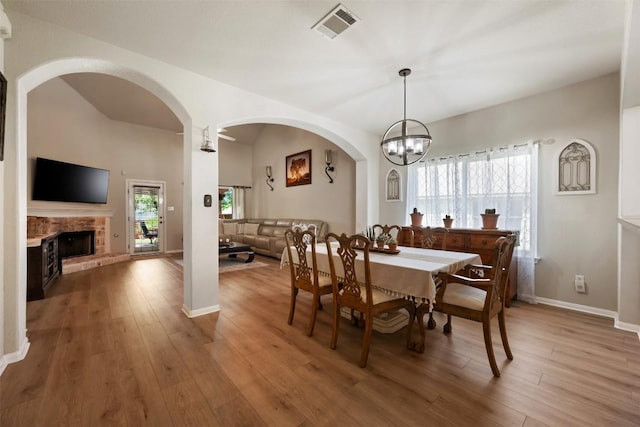 11113 Harvest Time Dr, Austin, TX 78754 - dining area featuring light wood-style floors, arched walkways, healthy amount of natural light, and baseboards