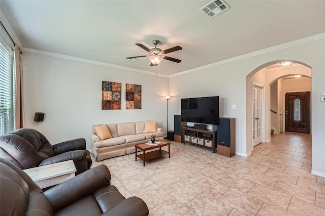 2712 Auburn Chestnut Ln, Pflugerville, TX 78660 - living room featuring arched walkways, ceiling fan, crown molding, and baseboards