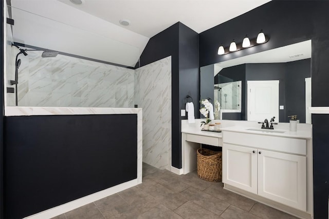 200 Wild Sage Ln, Liberty Hill, TX 78642 - bathroom featuring a marble finish shower, vanity, and vaulted ceiling