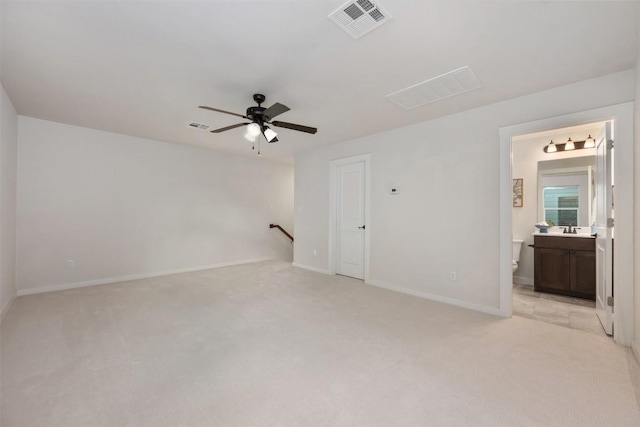 200 Wild Sage Ln, Liberty Hill, TX 78642 - spare room featuring light colored carpet, ceiling fan, baseboards, and a sink