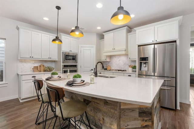 200 Wild Sage Ln, Liberty Hill, TX 78642 - kitchen with appliances with stainless steel finishes, a sink, light countertops, white cabinetry, and recessed lighting